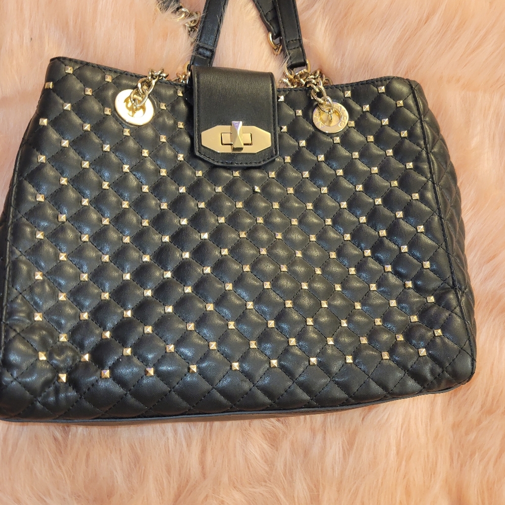 Black amd gold studded purse. Very nice and elegant, a nice touch to your outfit